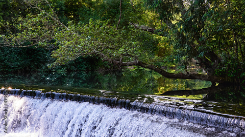 Closeup of a waterfall on the Caima river with foliage reflection photo