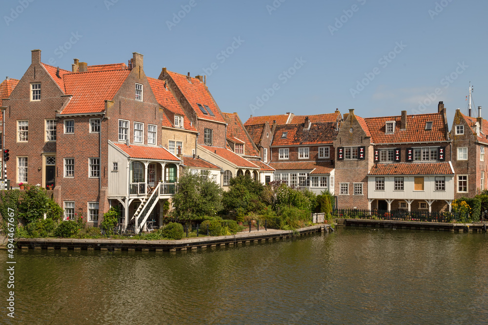 Historic canal houses on the old harbor of the picturesque town of Enkhuizen in West Friesland.