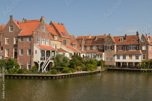 Historic canal houses on the old harbor of the picturesque town of Enkhuizen in West Friesland.