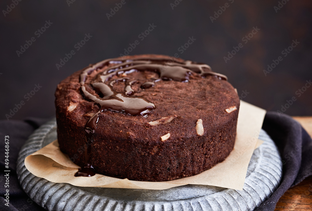 Healthy chocolate cake with almonds non sugar on a plate on the old wooden background. Selective focus. Keto diet. Healthy chocolate cake with almonds non sugar on a plate on the old wooden background. Selective focus. Keto diet.