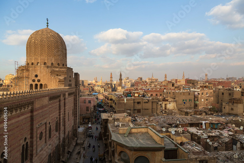 Cairo, Egypt - January 2022: Areal view over Al Muayyad Mosque, located next to Bab Zuweila, and the city centre at sunset