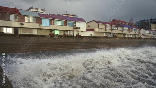 Waves crash on the embankment. 4k footage photo