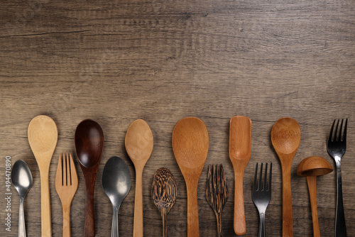 Varity of wooden metal plastic spoon kitchen tableware on rustic wood background copy text space