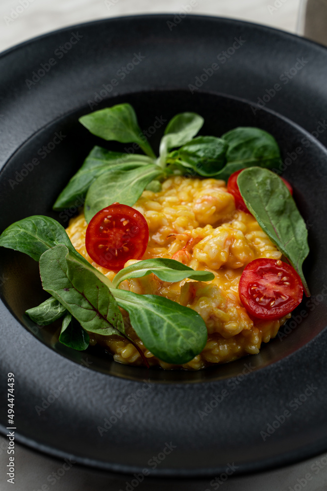 Rich cream mango risotto with prawns, modern fusion cuisine, bright on black, appetizing photo Rich cream mango risotto with prawns, modern fusion cuisine, bright on black, appetizing photo