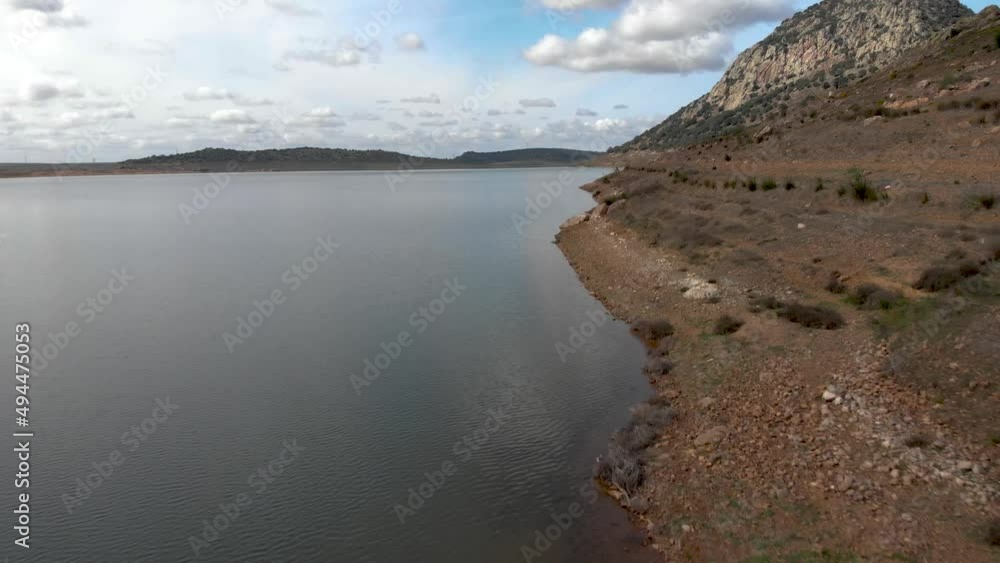 Aerial images flying at low altitude over the shore of a reservoir on a magnificent cloudy day. Aerial images flying at low altitude over the shore of a reservoir on a magnificent cloudy day.