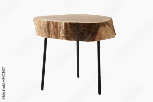 Shot of a three legged stool made of wood trunk and steel isolated on a white background photo