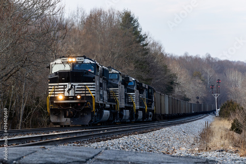 Moving vintage Norfolk Southern cargo train with CPL signals in the background
