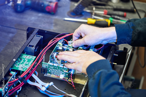 Repairing Hardware Equipment. Repair Shop and Worker with Tools.  Microchip and Circuit Board. Testing Modern Digital Device on Desk . Electronic Devices Concept.