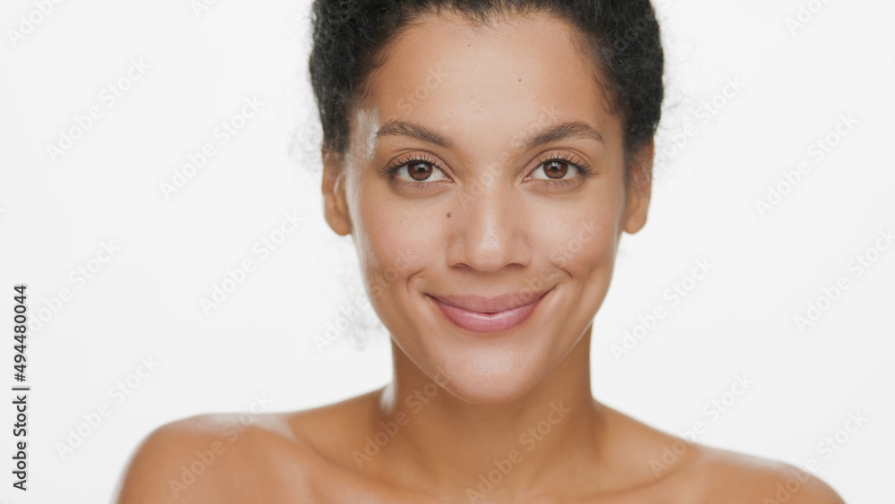 Close-up beauty portrait of young positive African American woman smiling for the camera on white background | Soft skin concept Close-up beauty portrait of young positive African American woman smiling for the camera on white background | Soft skin concept