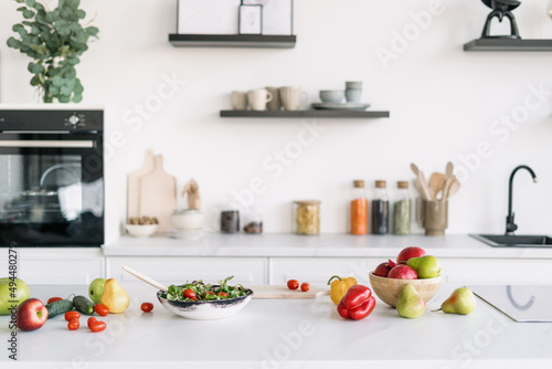 Variety of fruit and vegetables on table in kitchen