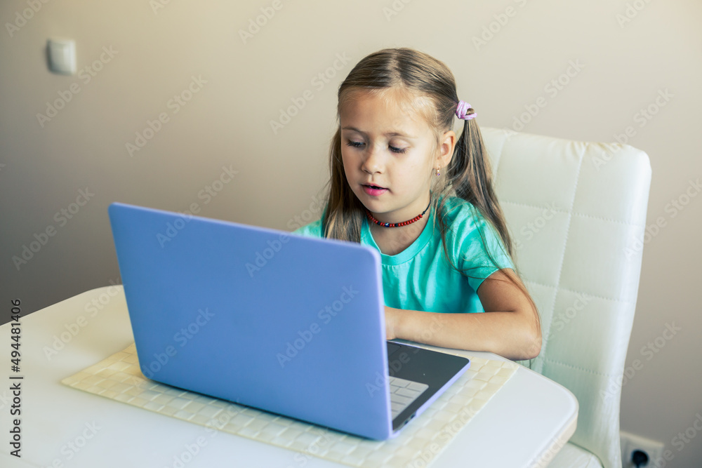 Little cute girl opens laptop to have video call Little cute girl opens laptop to have video call