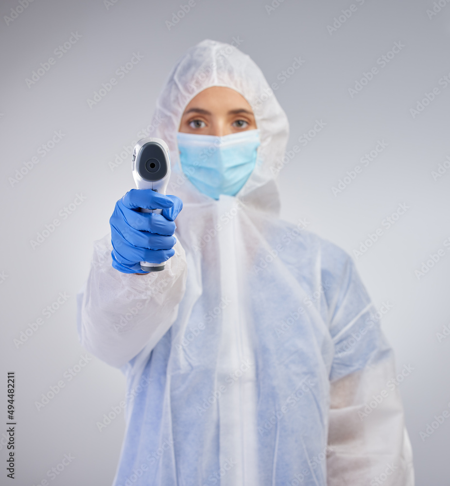 Your temperature tells us if youre ill. Shot of a young female nurse holding a digital thermometer against a studio background. Your temperature tells us if youre ill. Shot of a young female nurse holding a digital thermometer against a studio background.