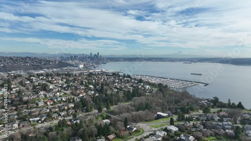 Cinematic 4K aerial drone dolly in shot of Southeast Magnolia Park, Interbay, Carlton Park, Briarcliff, Smith Cove, with panoramic view of Seattle, Washington photo