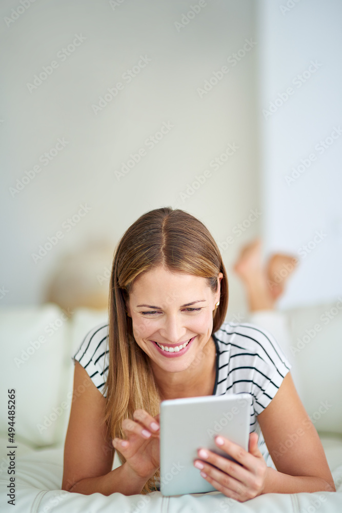 Enjoying some memes. Shot of a young woman browsing the internet at home. Enjoying some memes. Shot of a young woman browsing the internet at home.