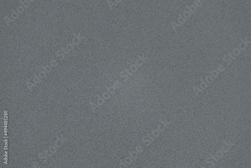Blank, even gray background with fine texture. Neutral backdrop for ads