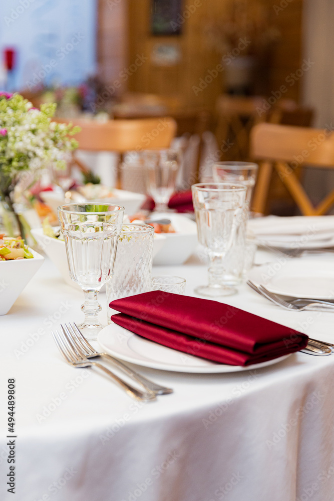 Fototapeta premium beautifully set tables with glasses and appliances for a wedding or other event