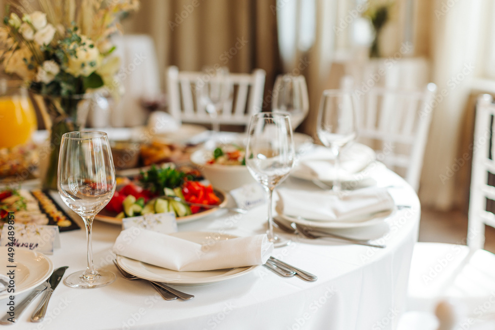 beautifully set tables with glasses and appliances for a wedding or other event beautifully set tables with glasses and appliances for a wedding or other event