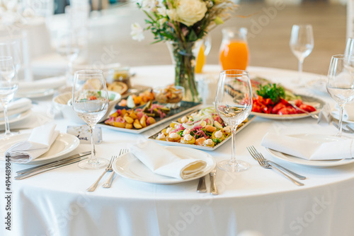 beautifully set tables with glasses and appliances for a wedding or other event