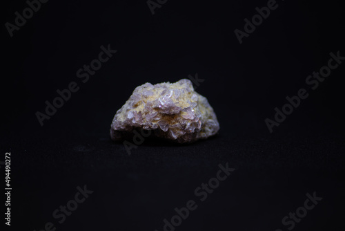 Closeup of a lepidolite mineral on black background
