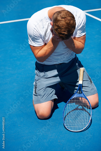 The agony of defeat. Shot of a man after losing a tennis match.