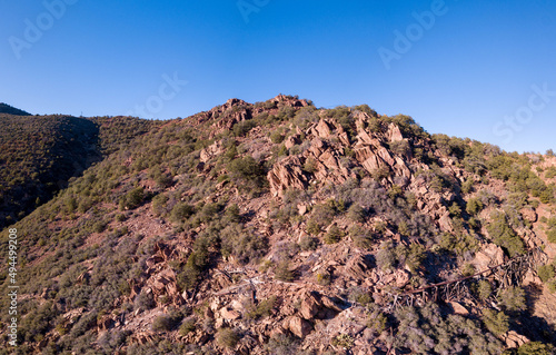 Large rocky mountain with trees and the ruins of a mine in Jerome, Arizona, USA photo