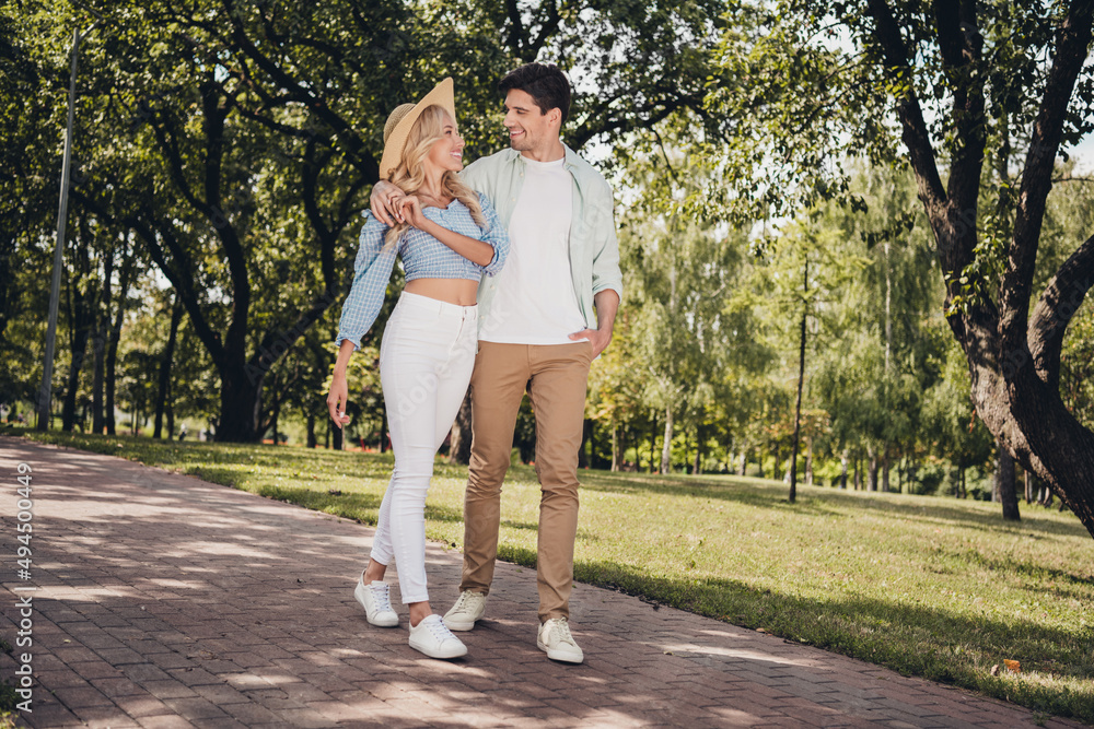Full length body size view of two attractive cheerful adorable couple strolling rest pastime hugging outdoors Full length body size view of two attractive cheerful adorable couple strolling rest pastime hugging outdoors