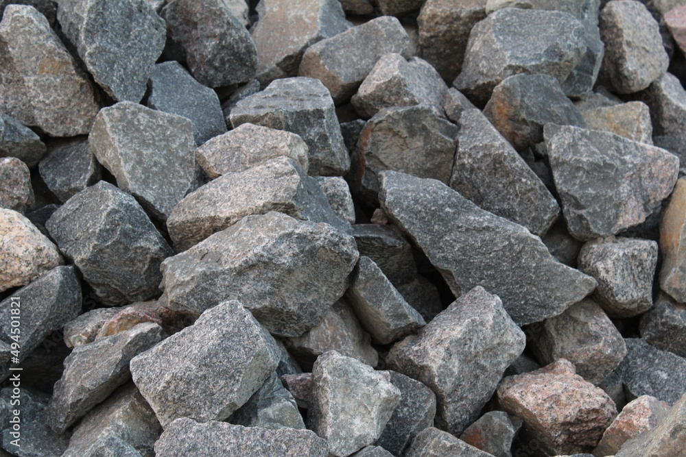 a background of cobblestone stones close-up. stones for the construction of the foundation. Crisis construction of expensive materials a background of cobblestone stones close-up. stones for the construction of the foundation. Crisis construction of expensive materials