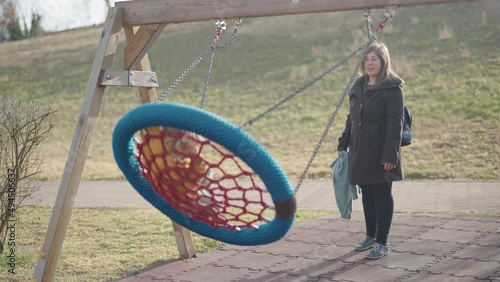 Wallpaper Mural Mother swinging child while he is resting in park 4K Torontodigital.ca