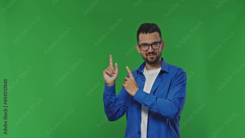 Young caucasian handsome dancing man pointing to the side on copy space, smiling surprised presenting something, natural and casual Young caucasian handsome dancing man pointing to the side on copy space, smiling surprised presenting something, natural and casual