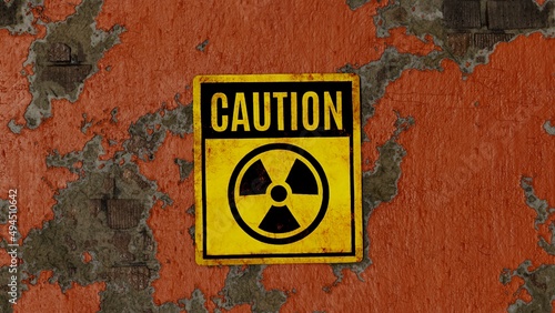 Photo Radioactivity sign - caution, on an orange painted peeling brick wall