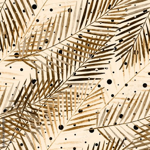 Seamless tropical pattern with palm leaves. Golden, brown palm leaves on a light beige background with polka dots.