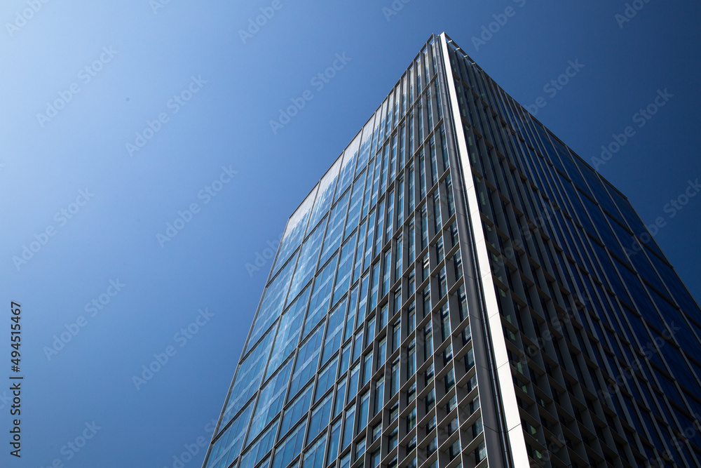 Skyscraper. Skyscraper against the blue sky. Glass and metal building, office and business center in a large city.