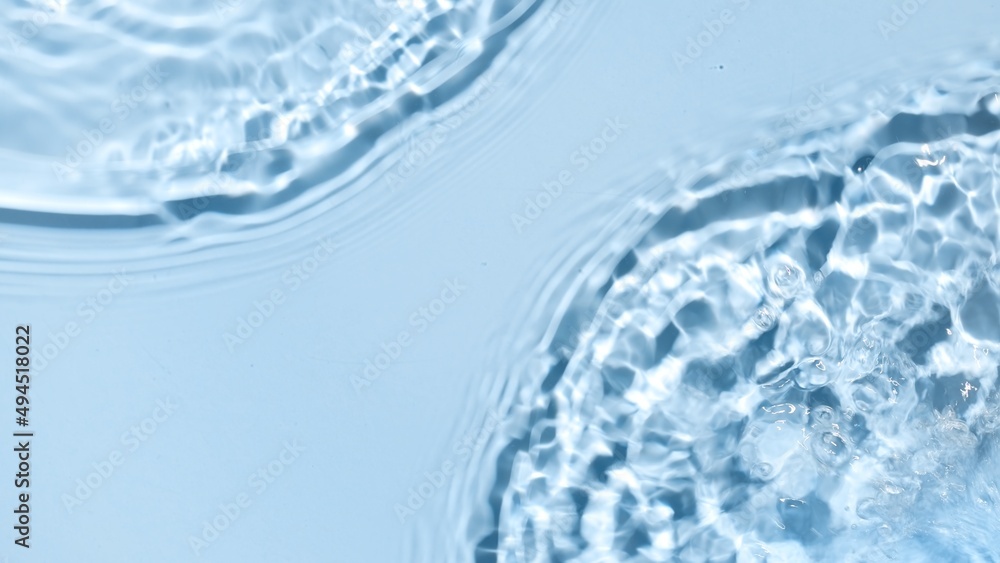 Poured water making two waves, splashes and ripples on blue background | skincare background, cleansing water commercial Poured water making two waves, splashes and ripples on blue background | skincare background, cleansing water commercial