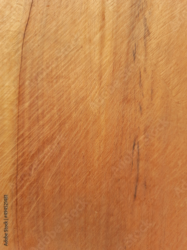 Vertical shot of a wooden surface with scratches on it photo