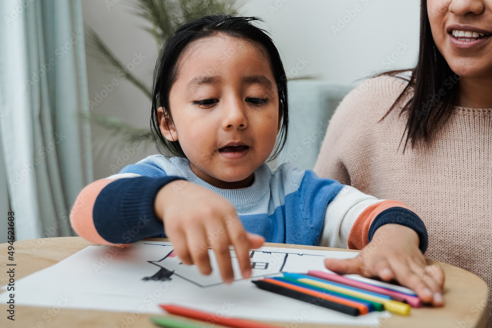 Happy latin american family having fun painting at home - Mother and son love concept - Focus on kid face Happy latin american family having fun painting at home - Mother and son love concept - Focus on kid face