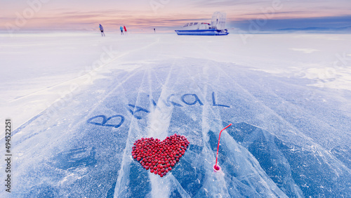 Cocktail drink winter ice kiss of Lake Baikal with cranberry heart. Concept travel Russia photo