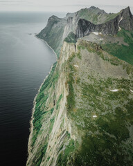 Fototapete Khaki Neblige Berge mit Meerblick  © Andreas Eriksen/Wirestock Creators