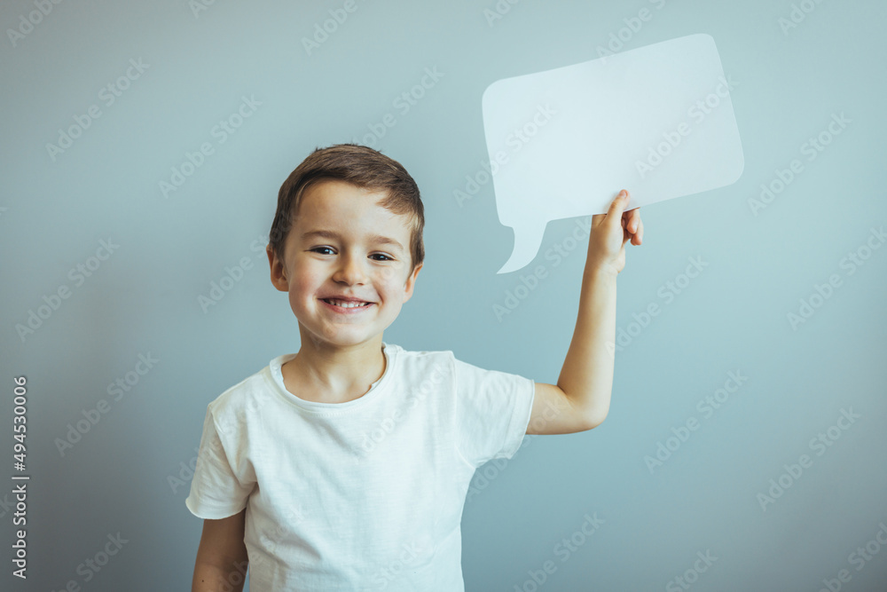 Little amazed boy in t-shirt holding blank white message box. Boy ...