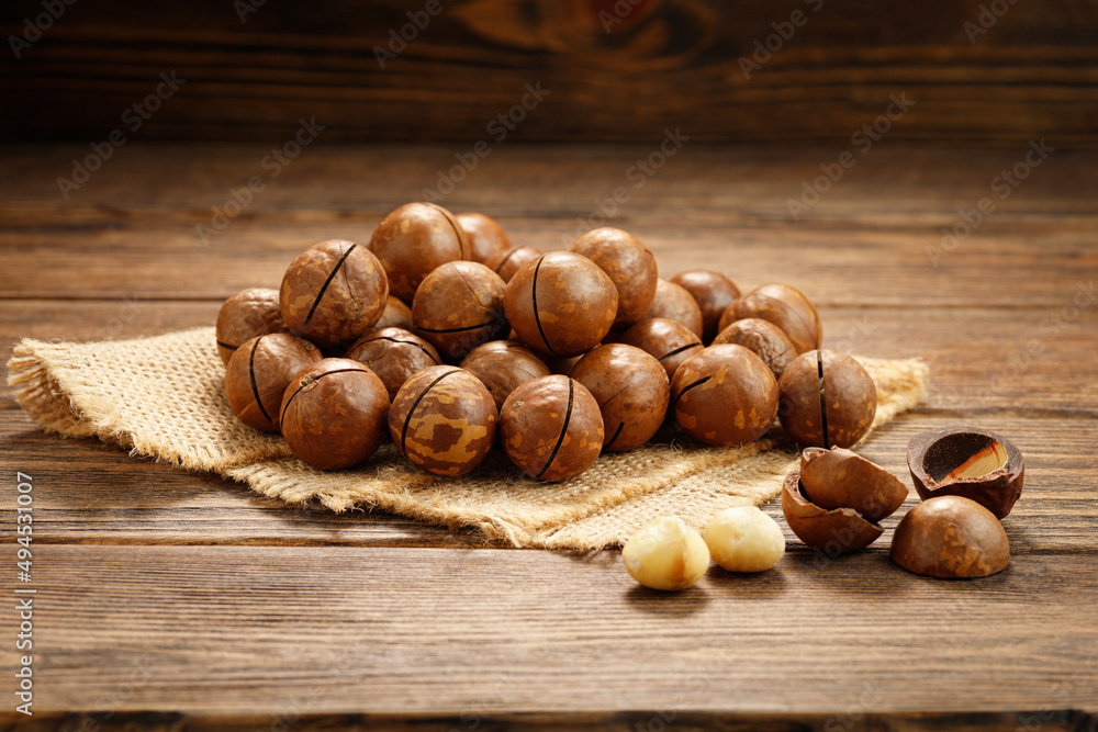 Macadamia nuts on a wooden table. Macadamia nuts on a wooden table.