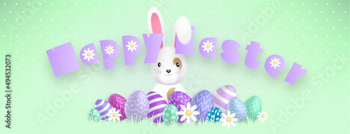 Happy Easter purple text, with a cute white bunny behind colored eggs and flowers on a green background