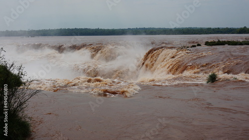 waterfalls of iguazu during flood brown water photo
