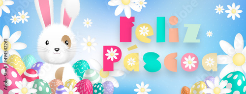 Spanish text with sweet colors : Feliz Pascoa, with a cute white rabbit behind colored eggs and flowers on a blue background
