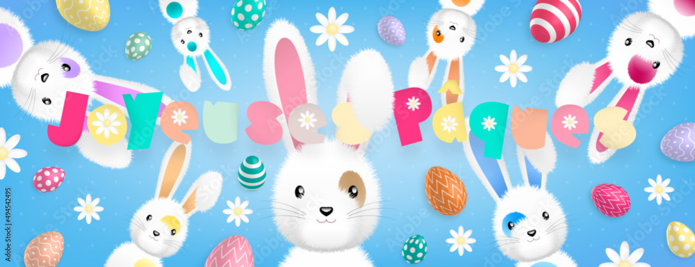 Texte «Joyeuses Pâques» aux couleurs pastels et de nombreux lapins dispersés autour accompagnés d’oeufs colorés et de fleurs sur un fond bleu Texte «Joyeuses Pâques» aux couleurs pastels et de nombreux lapins dispersés autour accompagnés d’oeufs colorés et de fleurs sur un fond bleu