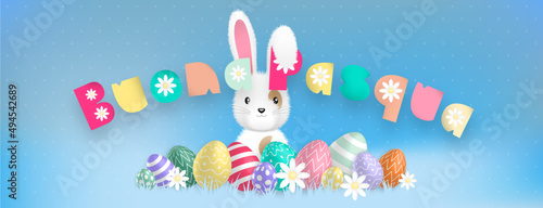 Italian text with sweet colors : Buona Pasqua, with a cute white bunny behind colored eggs and flowers on a blue background