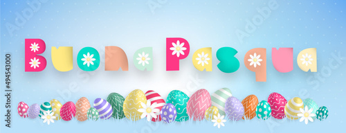Italian text with sweet colors : Buona Pasqua, with many colored eggs and flowers aligned on a blue background