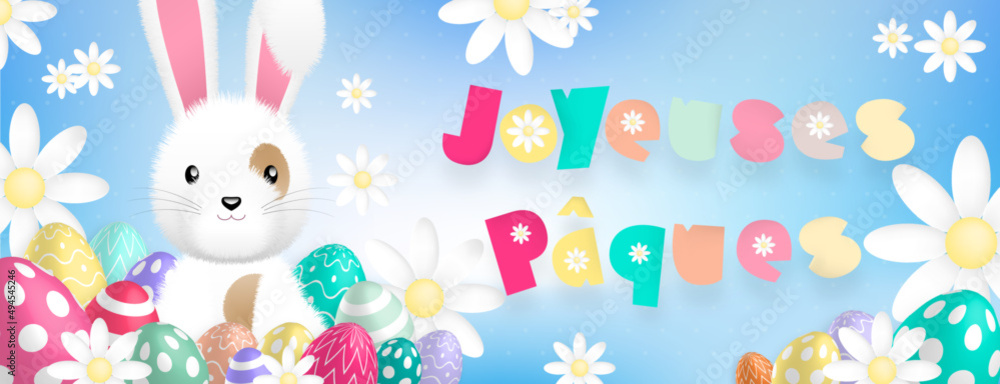 Texte «Joyeuses Pâques» aux couleurs pastels, avec un mignon lapin blanc derriere des oeufs colorés et des fleurs sur un fond bleu Texte «Joyeuses Pâques» aux couleurs pastels, avec un mignon lapin blanc derriere des oeufs colorés et des fleurs sur un fond bleu