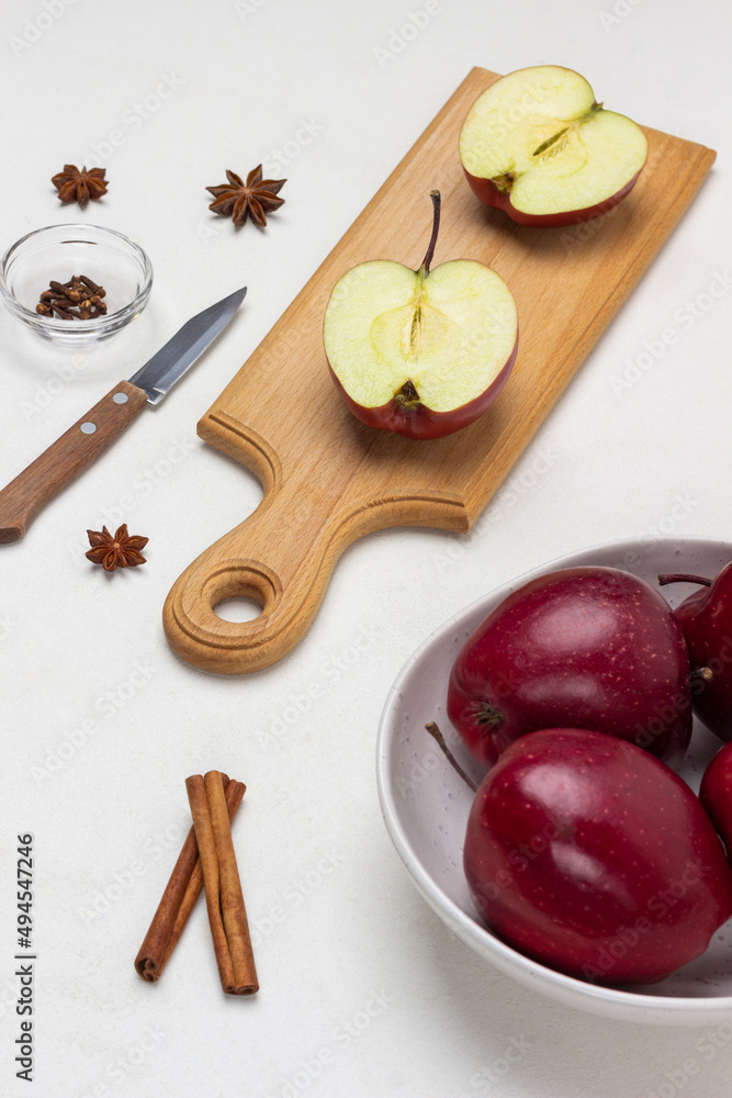 Apple halves on cutting board. Apples in bowl.