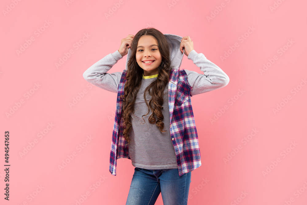smiling kid with curly hair on pink background, casual fashion smiling kid with curly hair on pink background, casual fashion