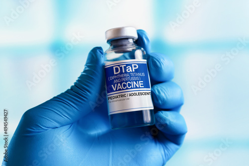Doctor with vial of doses vaccine for DTaP diphtheria, tetanus and Pertussis. Vaccination and health care concept. Vaccination for booster shot for DTaP diphtheria, tetanus and whooping cough in the c