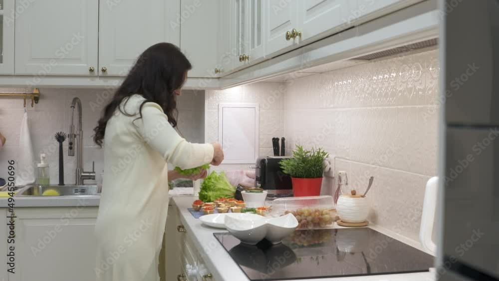 Woman cooking festive dinner in the kitchen making canape topped with savoury food. Appetizer canape with red caviar. High quality 4k footage Woman cooking festive dinner in the kitchen making canape topped with savoury food. Appetizer canape with red caviar. High quality 4k footage